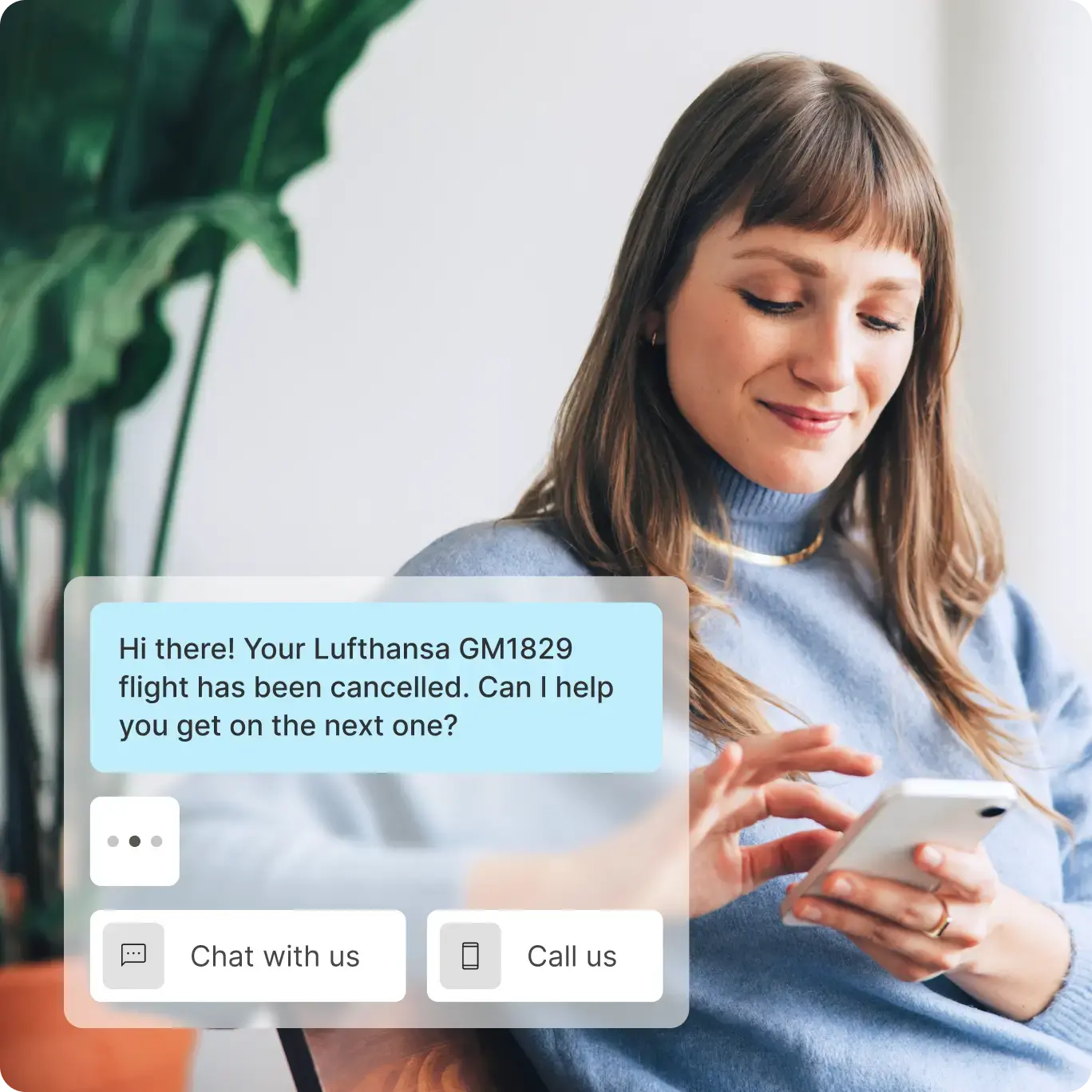 Smiling woman in a blue sweater using her smartphone, receiving a chat message about a canceled Lufthansa flight with options to chat or call for support.